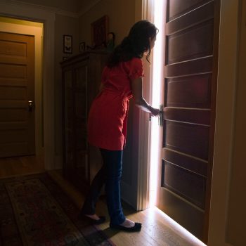 woman opening door