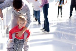 family skating at ice rink